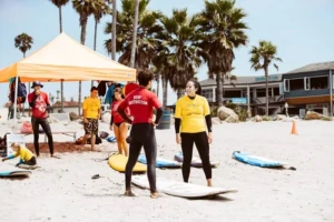 San Diego Surf School's instructor providing a private surf lesson on the beach