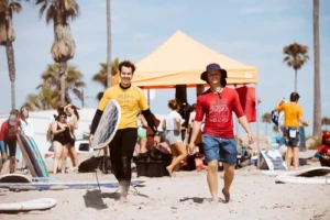 A surf instructor and customer walking to the beach in San Diego, during a private surf lesson.