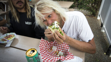 blonde guy eating a burrito