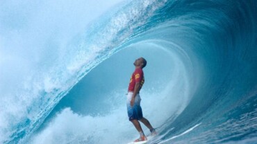 kelly slater standing in the barrel of a perfect wave